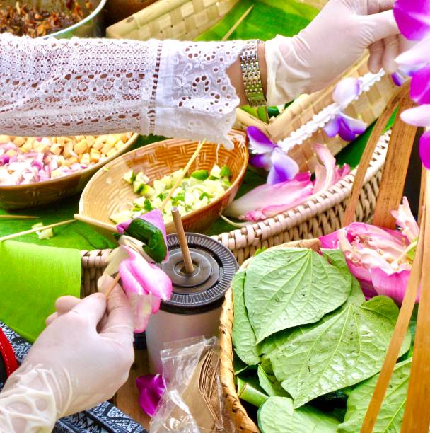istock Hand Holding Betel Leaf Wrapped Bite Size of Thai Appetizer 1199402315