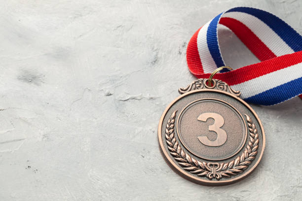 istock Bronze medal. Third place award with ribbon 1199402395