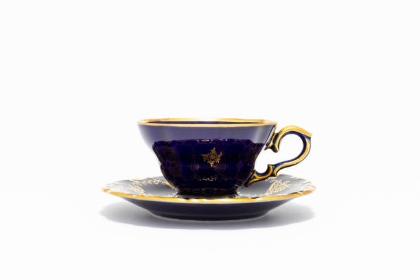 Beautiful cobalt blue colored vintage porcelain tea cup with gold ornament stock photo