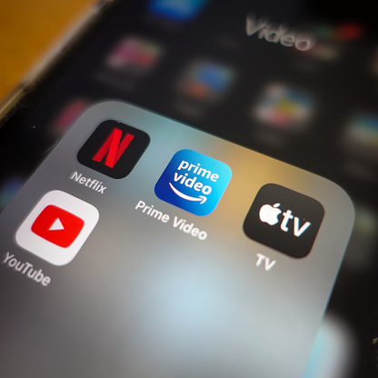 Italy, Rome - January 14 2020: The icon of the streaming app Amazon Prime, surrounded by other competitors app the screen of an iPhone. The main competitor for Amazon Prime are today Netflix, Apple TV and YouTube.