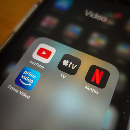 Italy, Rome - January 14 2020: The icon of the streaming app Apple TV+, surrounded by other competitors app the screen of an iPhone. The main competitor for Apple TV+ are today Amazon Prime, Netflix and YouTube.
