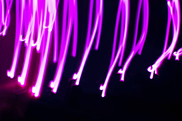 istock Abstract image of neon pink lights on a dark background. 1199408012