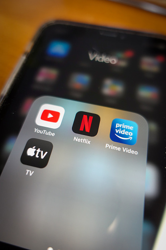 Italy, Rome - January 14 2020: The icon of the streaming app Netflix, surrounded by other competitors app the screen of an iPhone. The main competitor for Netflix are today Amazon Prime, Apple TV and YouTube.