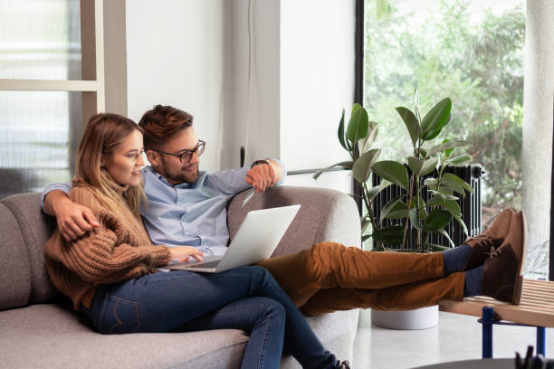 istock Young couple ordering online, looking in laptop 1199408117