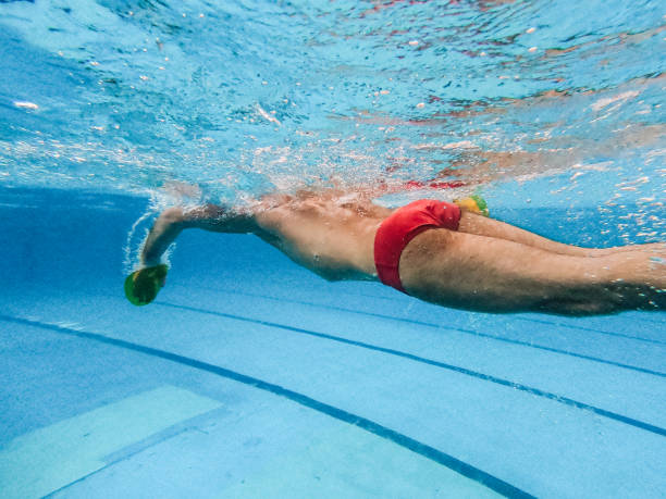 istock Mature swimmer swimming underwater 1199410077