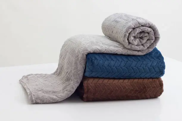 Photo of stack of folded soft blankets