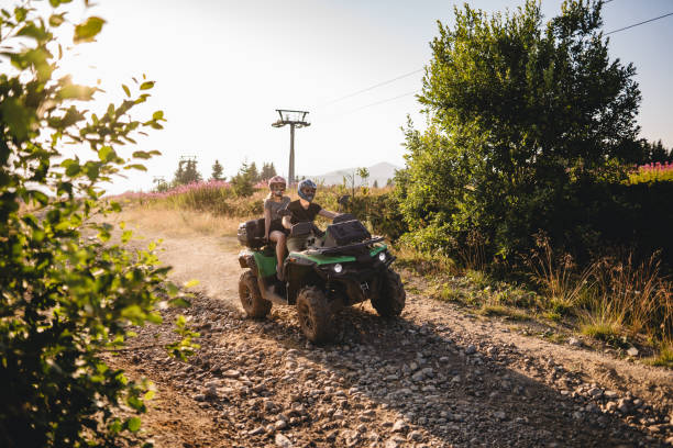 istock Couple exploring nature while driving quad bike 1199411410