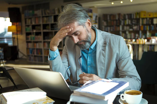 istock Mature adult man with laptop having trouble learning 1199411761