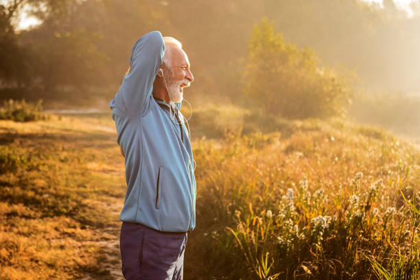istock Senior man stretching in park 1199411846
