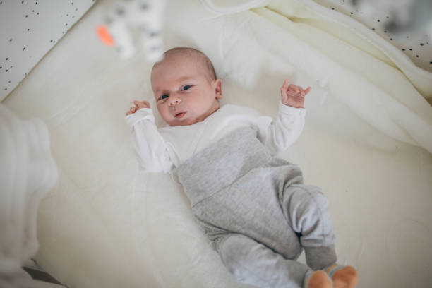 istock Beautiful baby boy lying in bed alone 1199412389