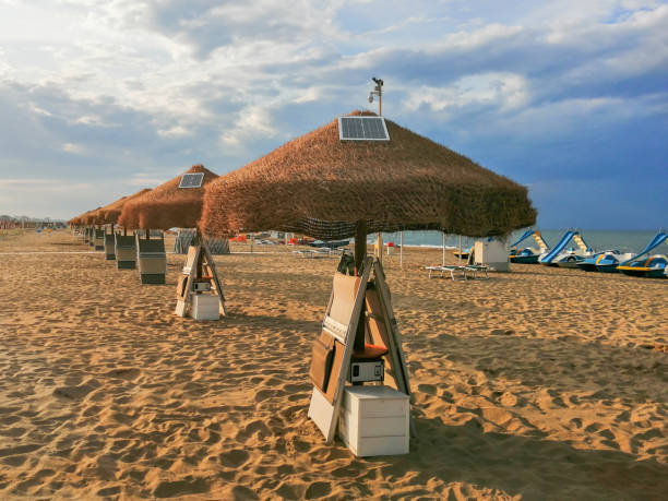 istock Solar panels mounted on a straw beach umbrella.Small electric solar panels 1199413276