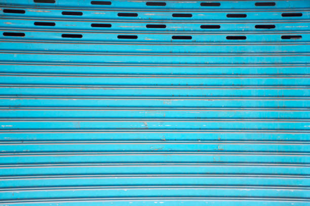 Blue steel sliding door. Shutter texture.