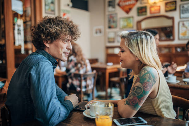 istock Modern man and woman sitting in cafe 1199416019