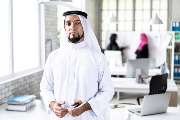 istock Arab businessman standing in modern office 1199419173
