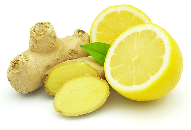 A fresh halved lemon and piece of root ginger stock photo