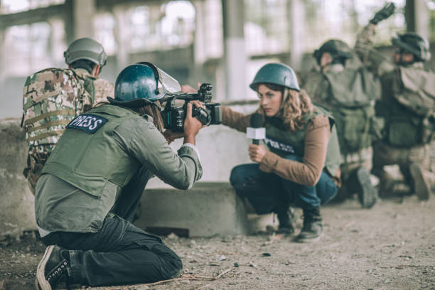istock War press reporting behind the soldiers in war zone 1199421209