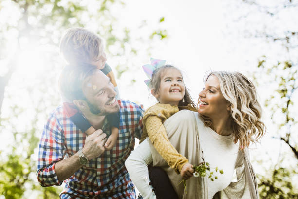 istock Playful family having fun while piggybacking in nature. 1199421254