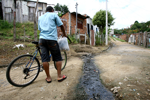 itabuna, bahia / brazil - march 2, 2012: Open sewage leak is seen on Sao Francisco Street in Bairro Novo Horizonte in the city of Itabuna.