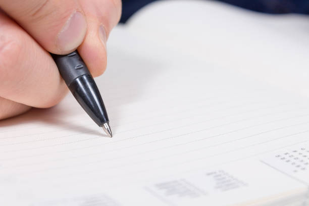 istock Personal finance. Young man writes in diary. 1199422605