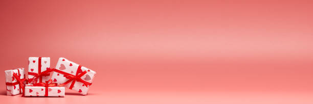 istock Gift boxes on pink background with copy space. Valentine's Day. Extra wide panorama banner background 1199422632