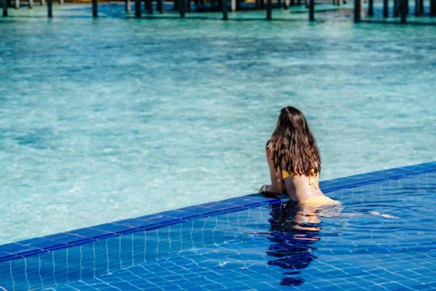 istock Attractive woman in a swimming pool 1199424584