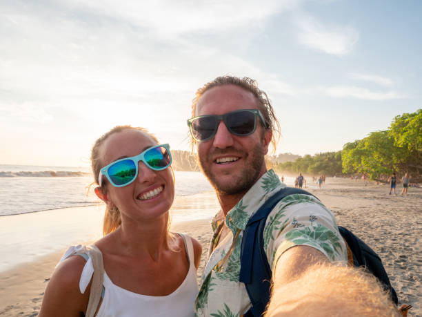 istock Young couple taking selfie on tropical beach 1199424856