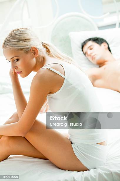 Portrait Of Unhappy Young Couple In Bedroom Stock Photo - Download Image Now - Adult, Adults Only, Arguing