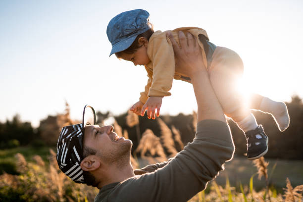 istock Young father playing with his daughter on sunny day 1199425796