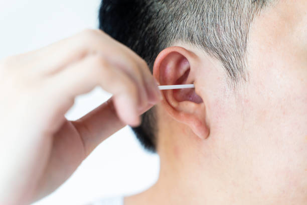 istock Man cleaning ears with cotton swabs 1199427257