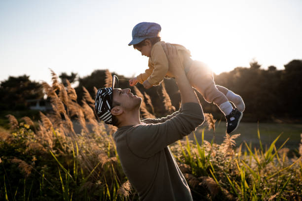 istock Young father playing with his daughter on sunny day 1199427343