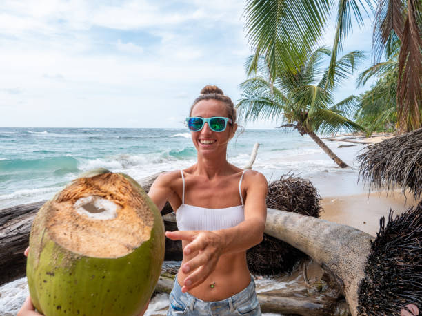 istock Couple sharing coconut on tropical beach 1199428948