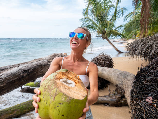 istock Couple sharing coconut on tropical beach 1199428950