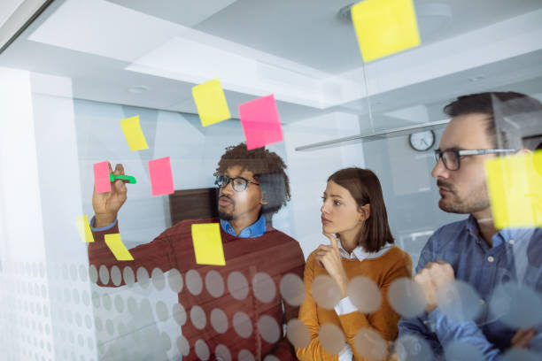 istock Business people brainstorming ideas behind glass wall 1199432509