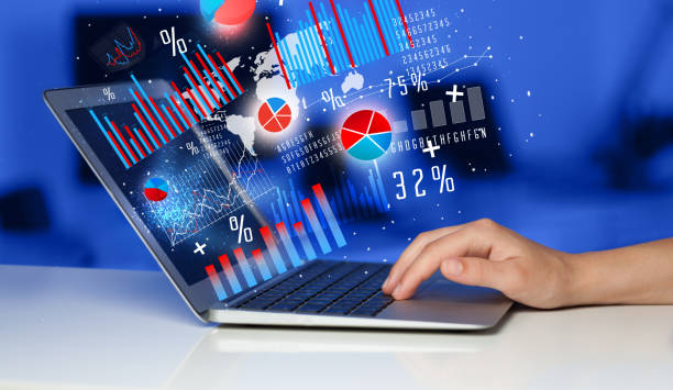 istock Hand typing on modern laptop notebook computer with graph icons and symbols 1199432645