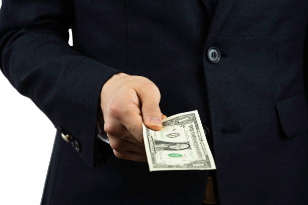 istock A man in a suit with a dollar in his hand. 1199432771