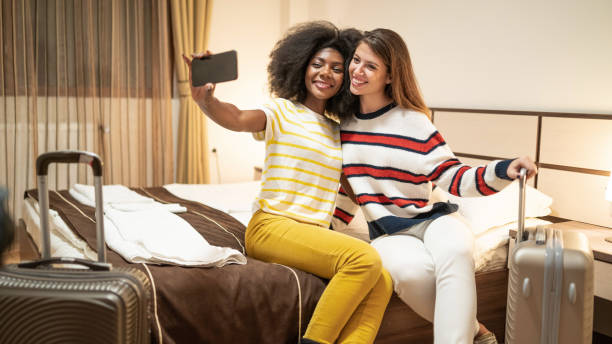 istock Two women taking selfie in the hotel room 1199433452