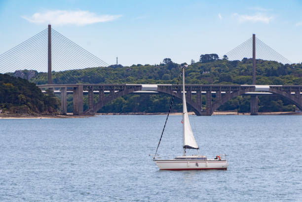 Sailboat near Iroise bridge Sailboat near Iroise bridge in Brest brest brittany stock pictures, royalty-free photos & images