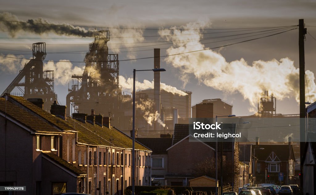Port Talbot Steel works Editorial PORT TALBOT, UK - JANUARY 04, 2020: The houses of Port Talbot and the emissions of the TATA Steel works that provides employment for the townsfolk. Steel Mill Stock Photo