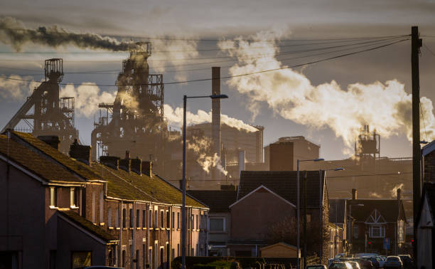 Port Talbot Steel works Editorial PORT TALBOT, UK - JANUARY 04, 2020: The houses of Port Talbot and the emissions of the TATA Steel works that provides employment for the townsfolk. particulate stock pictures, royalty-free photos & images