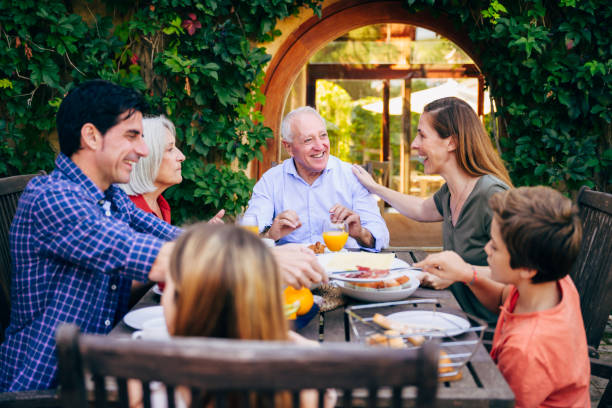 istock Multi-generation Spanish family enjoying outdoor meal 1199440176