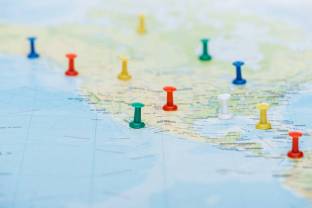istock selective focus of colorful push pins on world map with copy space 1199440532