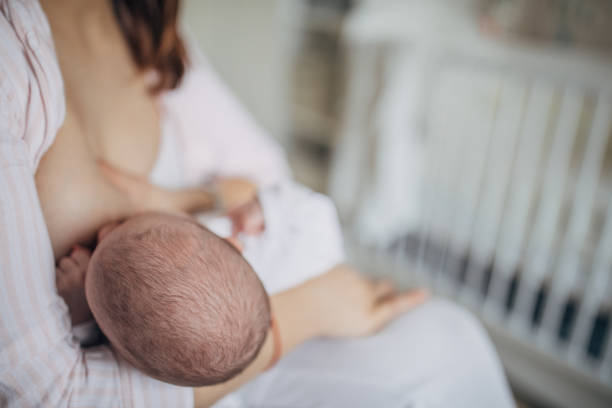 istock Mother breastfeeding her baby boy at home 1199441380
