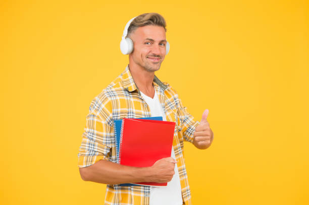istock Another way of study. Learning english. Educational technology. Study. Audio book concept. Worldwide knowledge access. Audio library. Man handsome college student headphones books. Study languages 1199441747