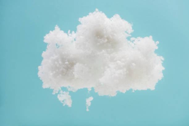 istock white fluffy cloud made of cotton wool isolated on blue background 1199442374