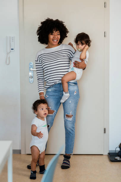 istock Mom and babies at home 1199443136