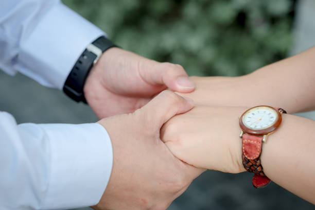istock Couple hold hands in green field /Valentine's Day 1199444355