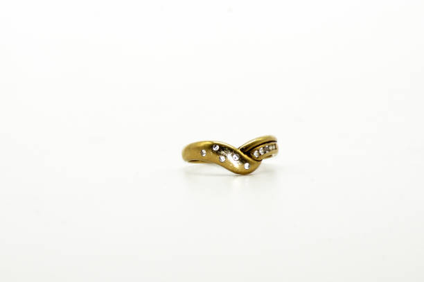 istock Old used gold ring exposed on white background 1199445228