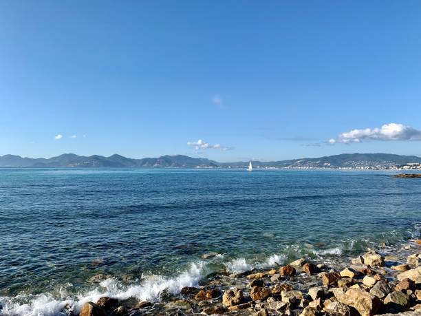 istock Blue sea and rocks in the foreground 1199445259