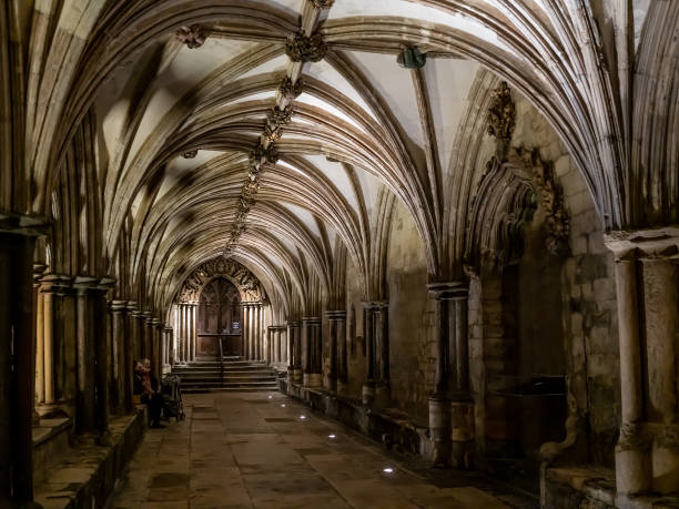 the cloisters of a cathedral captured at night - church gothic style cathedral dark imagens e fotografias de stock