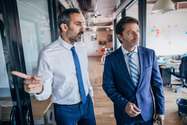 istock Modern businessmen in office building 1199447919
